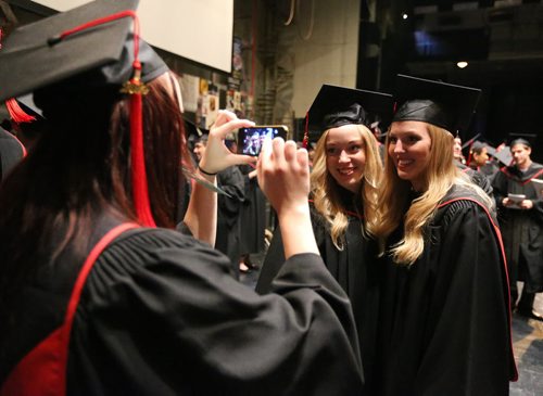 Creative Communications graduates Larissa Peck (second from right) and Audrey Neale (right) have their photo snapped by fellow Creative Communications grad Erica Miller backstage before the Red River College convocation for the School of Business and Applied Arts and the School of Continuing Education on Wed., June 4, 2014, at the Centennial Concert Hall. Photo by Jason Halstead/Winnipeg Free Press