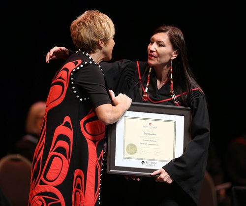Red River College president and CEO Stephanie Forsyth (left) presents the 2014 Honorary Diploma to film producer Lisa Meeches at the convocation for the School of Business and Applied Arts and the School of Continuing Education on Wed., June 4, 2014, at the Centennial Concert Hall. Photo by Jason Halstead/Winnipeg Free Press