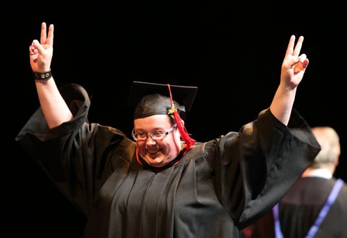 Laura Elizabeth Duggan, a graduate of 3-D Computer Graphics, reacts to cheering from the audience as she walks onstage to pick up her diploma at the Red River College convocation for the School of Business and Applied Arts and the School of Continuing Education on Wed., June 4, 2014, at the Centennial Concert Hall. Photo by Jason Halstead/Winnipeg Free Press