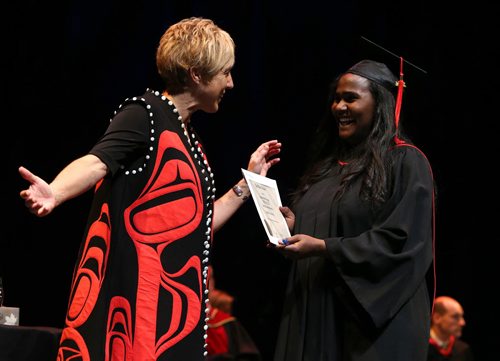 Applied Accounting graduate Lemlem Berhe Aregay (right) receives her diploma from Red River College president and CEO Stephanie Forsyth at the convocation for the School of Business and Applied Arts and the School of Continuing Education on Wed., June 4, 2014, at the Centennial Concert Hall. Photo by Jason Halstead/Winnipeg Free Press