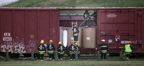 City Firefighters douse a fire in a box car parked at Wellington Ave and the Burlington Santa Fe Rail line Wednesday evening. (Beside Garbage Hill) June 4, 2014 - (Phil Hossack / Winnipeg Free Press)