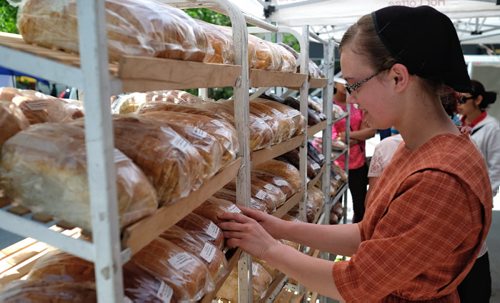 Margaret Weibe, 16, with the Market Basket stall at the Downtown Winnipeg Farmers Market which opened Thursday at the Manitoba Hydro Place Plaza and will be open every Thursday 10-4 until October.   140605 June 05, 2014 Mike Deal / Winnipeg Free Press