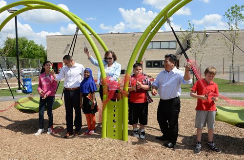 Children and youth opportunities minister Kevin Chief, school trustee Suzanne Hrynyk, city councillor Mike Pagtakhan and students Michael Cotu, Zam Hanson, Zelia Larosa and Silas Gutneck cut the ribbon at King Edward  School's opening of their new playground. Sarah Taylor / Winnipeg Free Press