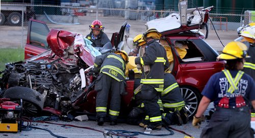 Emenrgency crews work to extract a man from his car after he rear ended a tractor trailer on Kenaston near Sterling Lyon Thursday evening. He was apparently concious but critical at the scene. June 5, 2014 (Phil Hossack / Winnipeg Free Press)
