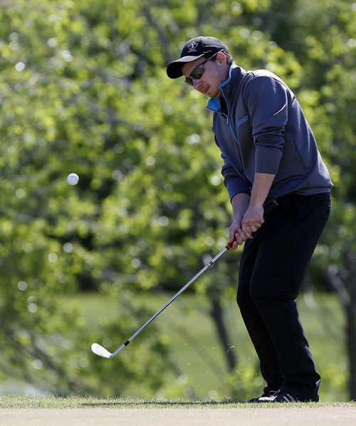 Bison team player Scott Mazur chips ball from the edge of the green into the hole on the 9th green .Manitoba wins the team event . 2014 Canadian University /College Golf Championship  at Southwood G&CC final day action  June 6 2014 / KEN GIGLIOTTI / WINNIPEG FREE PRESS
