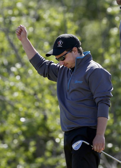 Bison team player Scott Mazur 's modest celebration after chiping  ball from the edge of the green into the hole on the 9th green .Manitoba wins the team event . 2014 Canadian University /College Golf Championship  at Southwood G&CC final day action  June 6 2014 / KEN GIGLIOTTI / WINNIPEG FREE PRESS