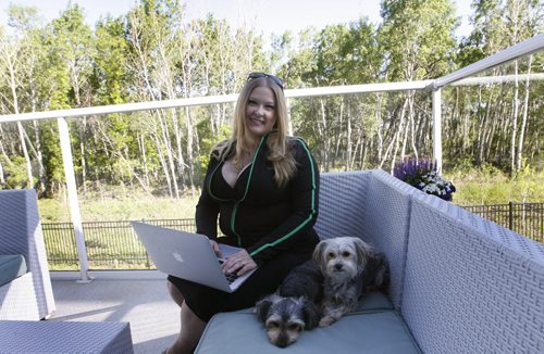 Our Winnipeg. Sunday Extra    Tara Maltman-Just on her deck at home with her dogs Calla and Lilly. Wayne Glowacki / Winnipeg Free Press June 6 2014