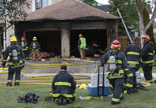 Firefighters do overhaul after fighting a fire Friday night at 2205 West Taylor Blvd-There was no one in the home during the blaze-  Breaking News- June 06, 2014   (JOE BRYKSA / WINNIPEG FREE PRESS)