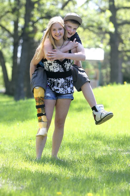 Naomi play fights as she hangs out with her little brother who recently had his right foot and part of his leg amputated.  Former Windsor School students face new challenges and take on new responsibilities in their first year in grade nine at Glen Lawn Collegiate. See Doug Speirs story. June 04, 2014 Ruth Bonneville / Winnipeg Free Press