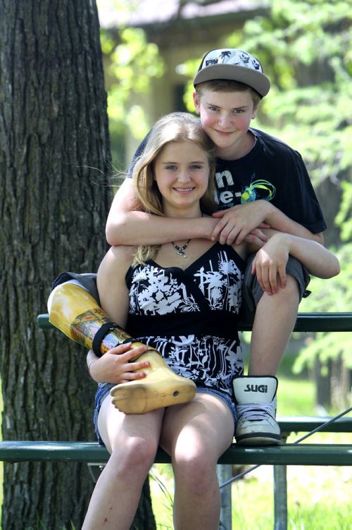 Naomi play fights as she hangs out with her little brother who recently had his right foot and part of his leg amputated.  Former Windsor School students face new challenges and take on new responsibilities in their first year in grade nine at Glen Lawn Collegiate. See Doug Speirs story. June 04, 2014 Ruth Bonneville / Winnipeg Free Press