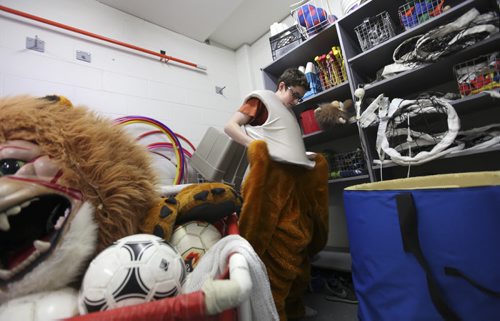 Noah puts on the schools mascot, a lion costume stored in the school gymnasium's equipment room at Glen Lawn Collegiate.  His role as the class clown at Windsor School seems to fit him well at his new school.  Former Windsor School students face new challenges and take on new responsibilities in their first year in grade nine at Glen Lawn Collegiate. See Doug Speirs story.  June 04, 2014 Ruth Bonneville / Winnipeg Free Press