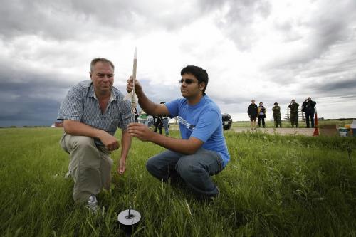 John Woods / Winnipeg Free Press / July 11/07- 070711  - Aman Thethy (R), a grade 11 student from Thompson. sets up the rocket he made at the Manitoba Space Adventure Camp with instructor Brian Baldwin at the St Charles Rifle Range Wednesday, July 11/07.