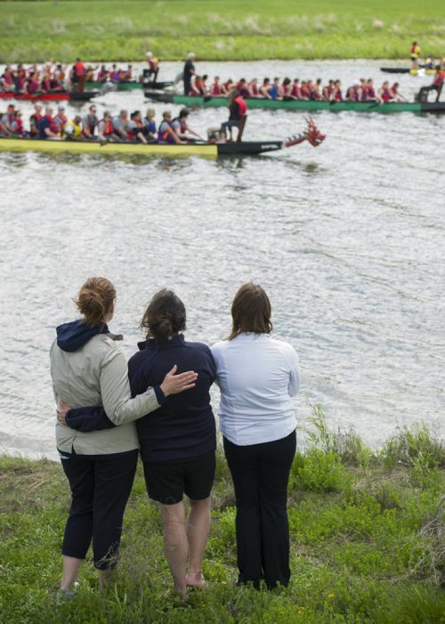 140607 Winnipeg - DAVID LIPNOWSKI / WINNIPEG FREE PRESS (June 07, 2014)

Kim Shepherd (centre) is comforted by her sister Cheryl Meyer (right), and friend Tammi Peters (left) as Dragon Boat competitors participate in a flower ceremony at the 2014 River City Dragon Boat Festival at the Manitoba Water Ski Park on Lake Shirley Saturday afternoon. One of the Dragon Boats, Kyle's Crusaders, was entered in honour of Kim Shpherd's son Kyle, who recentely died of cancer. Paddlers threw flowers into the water to honour cancer survivors and remember loved ones lost.