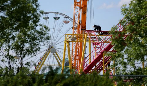 A worker assembles part of the Crazymouse Rollercoaster at Red River Exhibition Park prior to the Ex, which will be here June 13-22, Saturday, June 7, 2014. (TREVOR HAGAN/WINNIPEG FREE PRESS)
