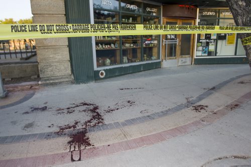 140607 Winnipeg - DAVID LIPNOWSKI / WINNIPEG FREE PRESS (June 07, 2014)  Blood spatters can be seen on the east sidewalk of Main Street between Alexander Ave and Logan Ave