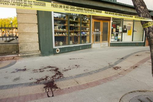 140607 Winnipeg - DAVID LIPNOWSKI / WINNIPEG FREE PRESS (June 07, 2014)  Blood spatters can be seen on the east sidewalk of Main Street between Alexander Ave and Logan Ave