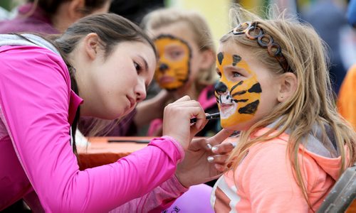 Shareen Hando paints the face of Danika Kontusiv, 7, at Kids Fest at The Forks, Sunday, June 8, 2014. (TREVOR HAGAN/WINNIPEG FREE PRESS)