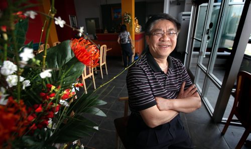 Vi-Ann restaurant, which was forced to close nearly two years ago when the Osborne Village property it had been in for 12 years was sold to Shopper's Drug Mart, is set to reopen tomorrow. Bac Bui, takes time out from decorating Monday to pose. See Geoff Kirbyson's story. June 9, 2014 - (Phil Hossack / Winnipeg Free Press)