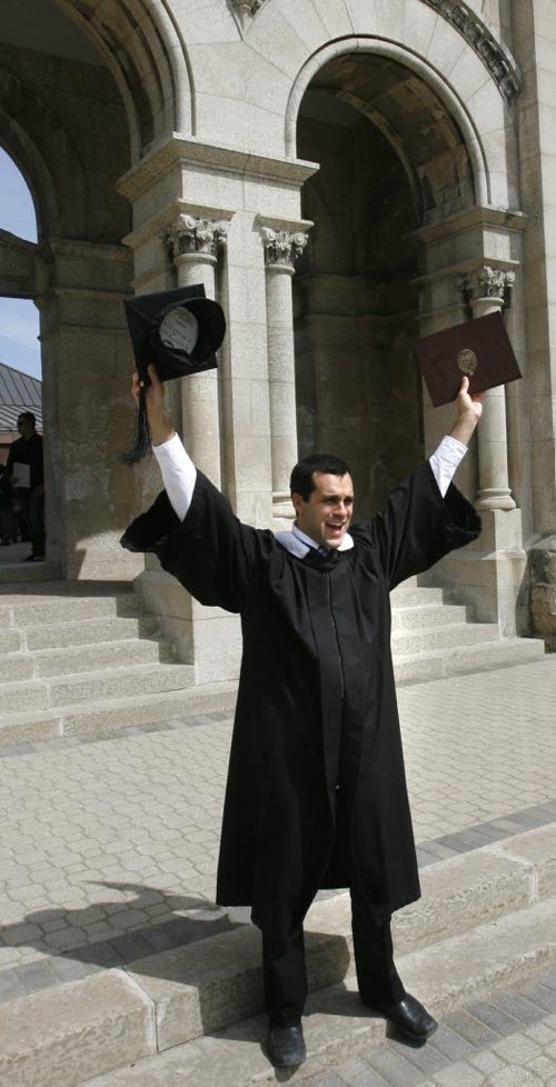 Joel Caby in the graduating class of Universite de Saint-Boniface, he poses for family photos after he received his Bachelor of Arts Degree at the University of Manitoba Convocation held in the Saint Boniface Cathedral Monday. Kevin Rollason story. Wayne Glowacki/Winnipeg Free Press May 9 2014