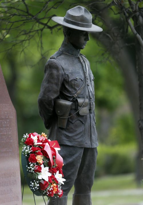 LOCAL - Wpg D Division headquarters for the RCMP memorial for RCMP officers who lost their lives on duty is adorned with flags , wreaths , flowers and messages of condolence on the day of the funerals for members killed in Moncton .  June 10 2014 / KEN GIGLIOTTI / WINNIPEG FREE PRESS
