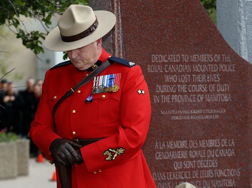 Const. Bruce Mellor one of two honourary sentries  during the ceremony  that included RCMP Chief Superintendent  (not in photo) Scott Kolody with honour guard  lays wreath . Winnipeg RCMP D Division held their own memorial service for slain members in Moncton NB. On Portage Ave  Tuesday Morning .  Äì the short wreath laying ceremony involved RCMP officers , staff at D Division , Wpg City Police  and members of the public  June 10 2014 / KEN GIGLIOTTI / WINNIPEG FREE PRESS