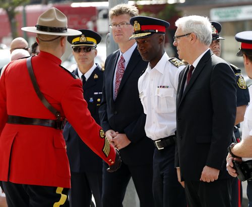 Dignitaries included Mb Attorney General Andrew Swan , WPS Chief Devon Clunis   MB premier Greg Selinger  during the ceremony  that included RCMP Chief Superintendent  (not in photo) Scott Kolody with honour guard  lays wreath . Winnipeg RCMP D Division held their own memorial service for slain members in Moncton NB. On Portage Ave  Tuesday Morning .  Äì the short wreath laying ceremony involved RCMP officers , staff at D Division , Wpg City Police  and members of the public  June 10 2014 / KEN GIGLIOTTI / WINNIPEG FREE PRESS