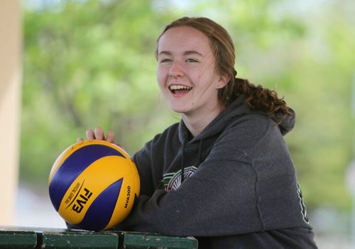 Sydney who was captain of the volleyball team sits with a volleyball over the lunch hour  with some of her former Windsor School friends . Former Windsor School students face new challenges and take on new responsibilities in their first year in grade nine at Glen Lawn Collegiate. See Doug Speirs story.  June 04, 2014 Ruth Bonneville / Winnipeg Free Press