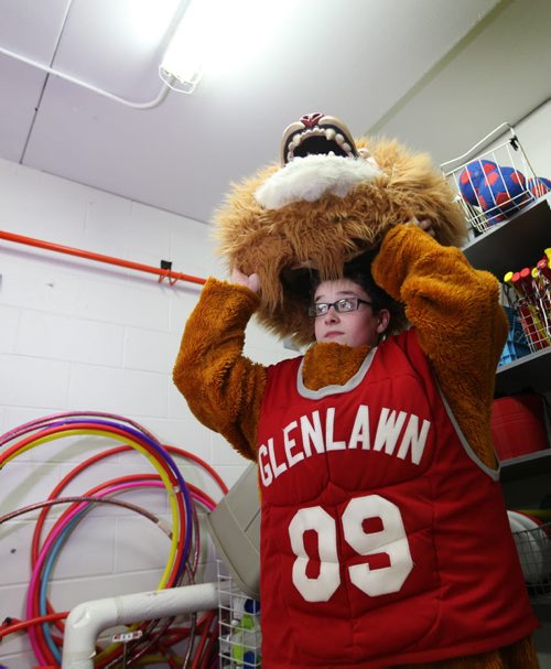Noah puts on the schools mascot, a lion costume stored in the school gymnasium's equipment room at Glen Lawn Collegiate.  His role as the class clown at Windsor School seems to fit him well at his new school.  Former Windsor School students face new challenges and take on new responsibilities in their first year in grade nine at Glenlawn Collegiate. See Doug Speirs story.  June 04, 2014 Ruth Bonneville / Winnipeg Free Press