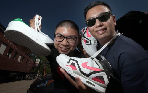 Jerry Legaspi (left) and Frendell Cano pose with a selection of sneakers Tuesday. The pair are organizers of the 2nd annual "Winnipeg Got Sole" sneaker swap See story. June 10, 2014 - (Phil Hossack / Winnipeg Free Press)