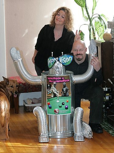 BORIS MINKEVICH / WINNIPEG FREE PRESS  070711 Audra Lesosky and George McRobb pose for a photo in their Rosedale Ave. home. SUNDAY PERSPECTIVE. Photo is with a robot  they built. FRINGE. Zoe the dog peeks into shot.