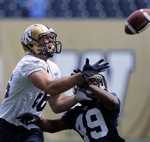 CB #49 gets a hand in early preventing #26 FB  carl Fitzgerald from making catch during 1on1 drill at ¬Blue Bomber training camp , preseason practice feature for Lawless  June 11 2014 / KEN GIGLIOTTI / WINNIPEG FREE PRESS