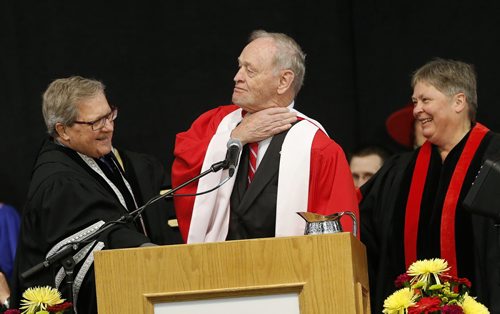 The honour is fitting at bit tight , sharing laugh are  -Left  Lloyd Axworthy President vice Chanceller of UofW and   right Justice Brenda Keyser .Chretien was  presented with an  honourary degree. UofW Convocation , Jean Chretien receives honorary degree and gave the  keynote  address . June 12 2014 / KEN GIGLIOTTI / WINNIPEG FREE PRESS