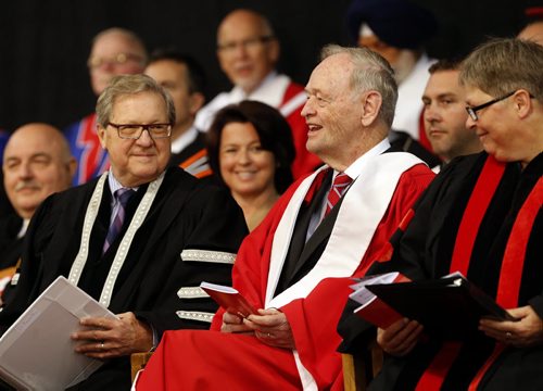 LOCAL . 103rfd UofW Convocation , Jean Chretien shares smile  with (left) Lloyd Axworthy UofW President and Vice-Chancellor during opening remarks ,Chretien   received honorary degree and gaves an address to studenst at the convocation   . with story June 12 2014 / KEN GIGLIOTTI / WINNIPEG FREE PRESS