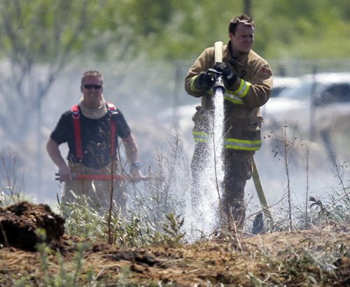 LOCAL - Grass fire in behind businesses on Gunn Road. Crews from the RM of Springfield battled the pesky blaze all after noon. BORIS MINKEVICH / WINNIPEG FREE PRESS  June 12, 2014