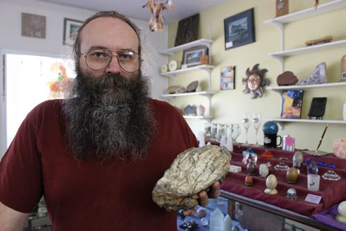 0590 - Souris Rock Shop owner Frank Grabowski holds up a fossilized mammoth tooth he found last year in the store's quarry. BILL REDEKOP/WINNIPEG FREE PRESS June 12, 2014