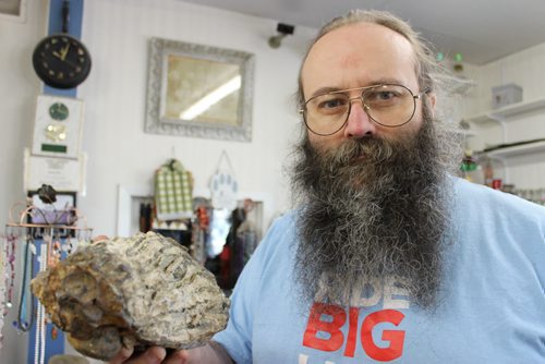115 - Souris Rock Shop owner Frank Grabowski holds up a fossilized mammoth tooth he found last year in the store's quarry. BILL REDEKOP/WINNIPEG FREE PRESS June 12, 2014