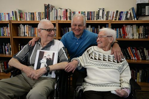 Werner Junghans holds his wedding photo next to his son Marc and wife of 66 years Erna. Sarah Taylor / Winnipeg Free Press