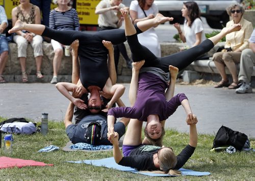 STDUP Exchange Stage  members of Acro Yoga Winnipeg members displayed there talents as the Winnipeg Jazz Festival's noon hour performance began , they were not part of show , they were just using the space  and fresh air and warm day to practice their art .  Front bottom Lesley Brown holds up Lauren Whittaker  and rear Dan Moroz holds up April Baker, June 13 2014 / KEN GIGLIOTTI / WINNIPEG FREE PRESS