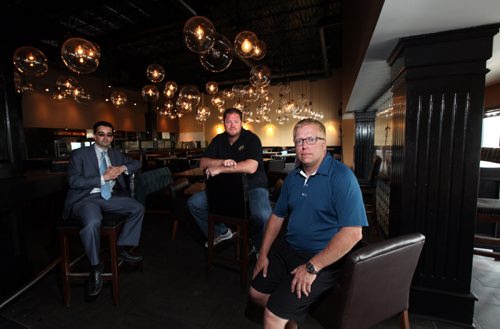 Left to right, MICHAEL STRONGER, a retail leasing specialist with Shindico Realty Inc., NOEL BERNIER, president of FB Hospitality, and DARCY CANERS, its vice-president of operations are the owners of the citys first craft beer pub -- Barley Brothers  plan to open an even bigger, better one this fall in the former Earls Restaurant on Pembina Highway. The trio pose inside the former Earls eatery. June 13, 2014 - (Phil Hossack / Winnipeg Free Press)