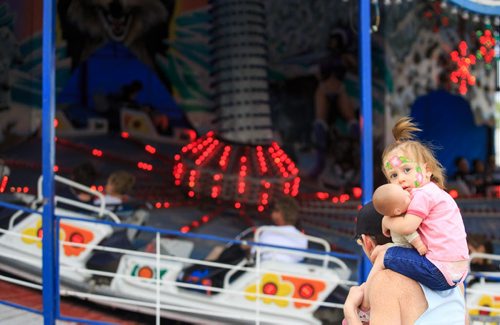 Aaliyah Bailey, 2, and her father John watched her grandfather on the Polar Express on the opening day of the Red River Ex Friday afternoon. Clouds and the threat of rain kept the number of visitors down. 140613 - Friday, June 13, 2014 - (Melissa Tait / Winnipeg Free Press)