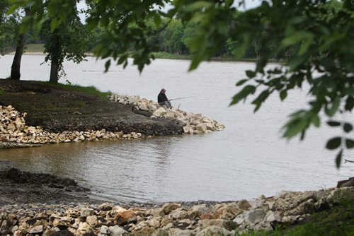 Matt Nicholls sits on the banks of the Red River in St. Vital Park Saturday taking advantage of the free fishing weekend this weekend.  Standup photo.  June 14, 2014 Ruth Bonneville / Winnipeg Free Press