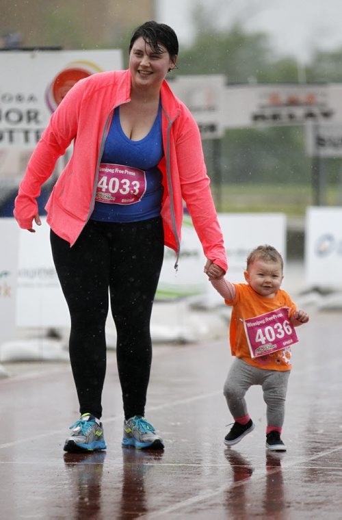 Brittany Savoie and her daughter, Ophelia Savoie, 1, near the finish line of the Winnipeg Free Press 10k during the Manitoba Marathon at the University of Manitoba, Sunday, June 15, 2014. (TREVOR HAGAN/WINNIPEG FREE PRESS)