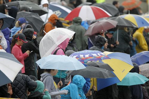 Spectators and supporters with umbrella's during the Manitoba Marathon at the University of Manitoba, Sunday, June 15, 2014. (TREVOR HAGAN/WINNIPEG FREE PRESS)