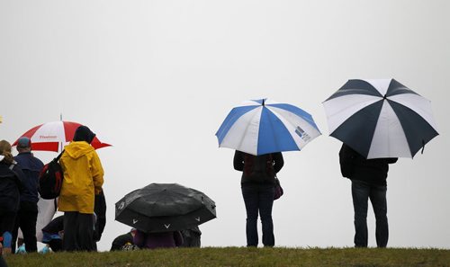 Spectators and supporters with umbrella's during the Manitoba Marathon at the University of Manitoba, Sunday, June 15, 2014. (TREVOR HAGAN/WINNIPEG FREE PRESS)