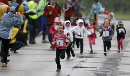 Emma Pauls, 5, wins the Mini Mites race at the Manitoba Marathon at the University of Manitoba, Sunday, June 15, 2014. (TREVOR HAGAN/WINNIPEG FREE PRESS)