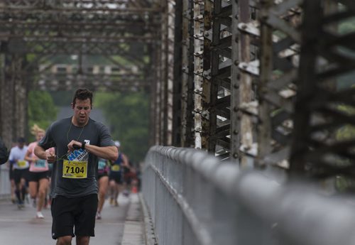 Runners head over the Elm Park Bridge an hour into the marathon. Sarah Taylor / Winnipeg Free Press