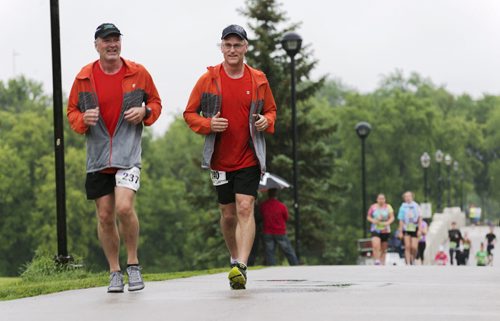 Runners head over the Assinboine park foot bridge. Sarah Taylor / Winnipeg Free Press