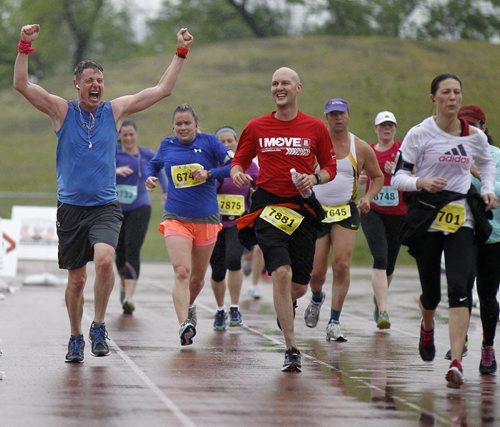 Phillip Duncan, left, and Jason Campbell, middle, near the finish line during the Manitoba Marathon at the University of Manitoba, Sunday, June 15, 2014. (TREVOR HAGAN/WINNIPEG FREE PRESS)