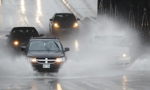 June 15, 2014 - 140615  -  Vehicles charge through large puddles on McPhillips Sunday, June 15, 2014. John Woods / Winnipeg Free Press