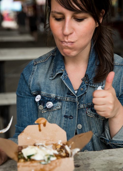 Reporter Jen Zoratti approves of the Fisherman poutine at the Poutine King truck. Traditional poutine with smoked salmon, brie, sour cream, fresh dill and capers. Red River Ex food reviews - Jen Zoratti story 140613 - Friday, June 13, 2014 - (Melissa Tait / Winnipeg Free Press)